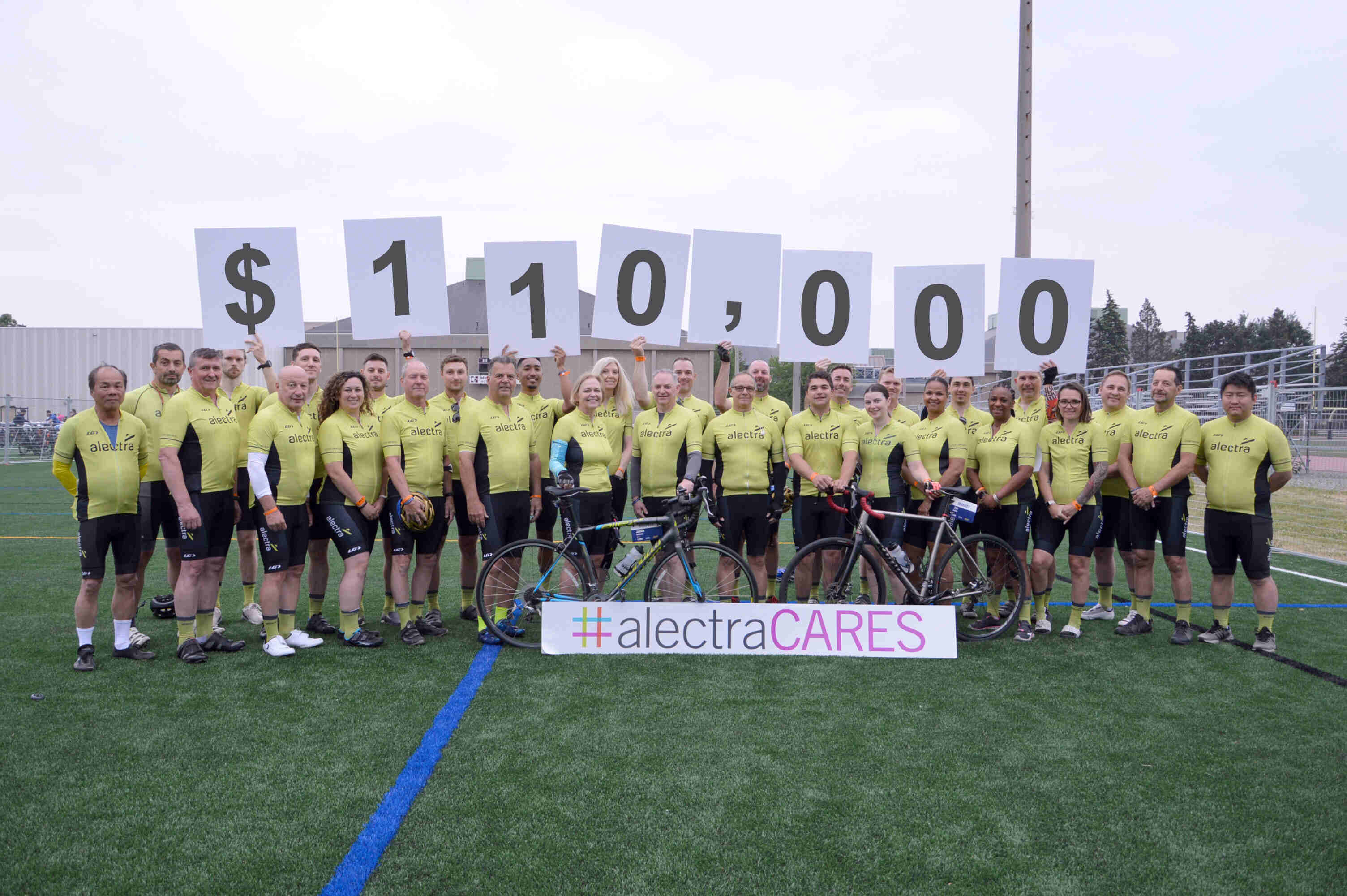 Group shot at Ride to Conquer Cancer with people holding a sign saying $110,000