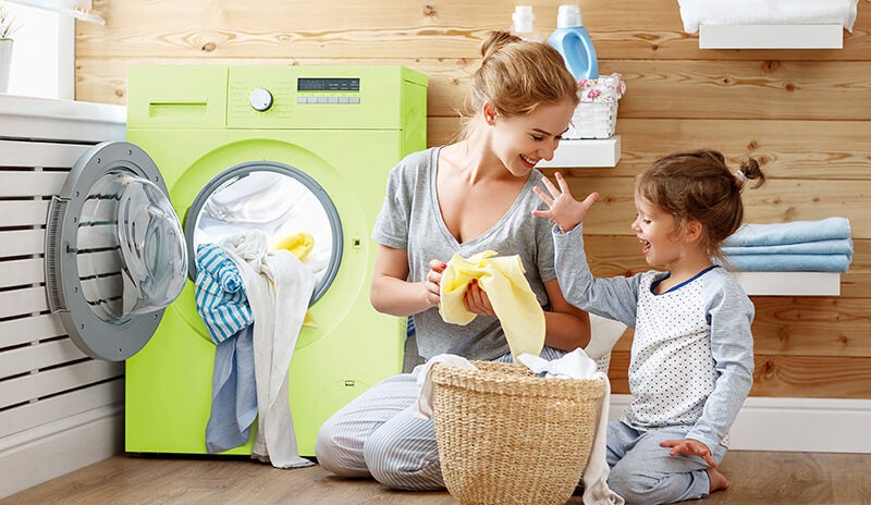 A mother and child sorting laundry at home