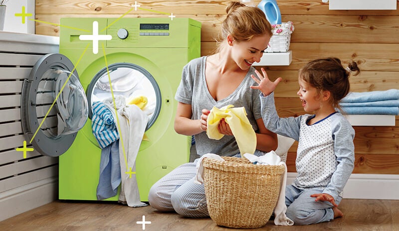 A mother and child sorting laundry at home