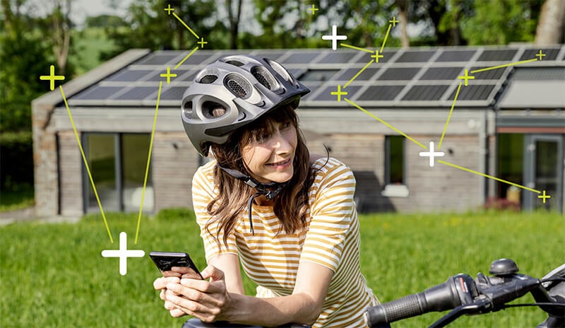 Girl laying on a bike with solar panels on a house in background