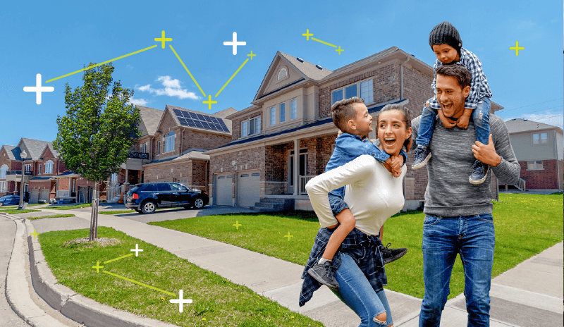 A happy family of 4 people enjoying in front of a solar powered house