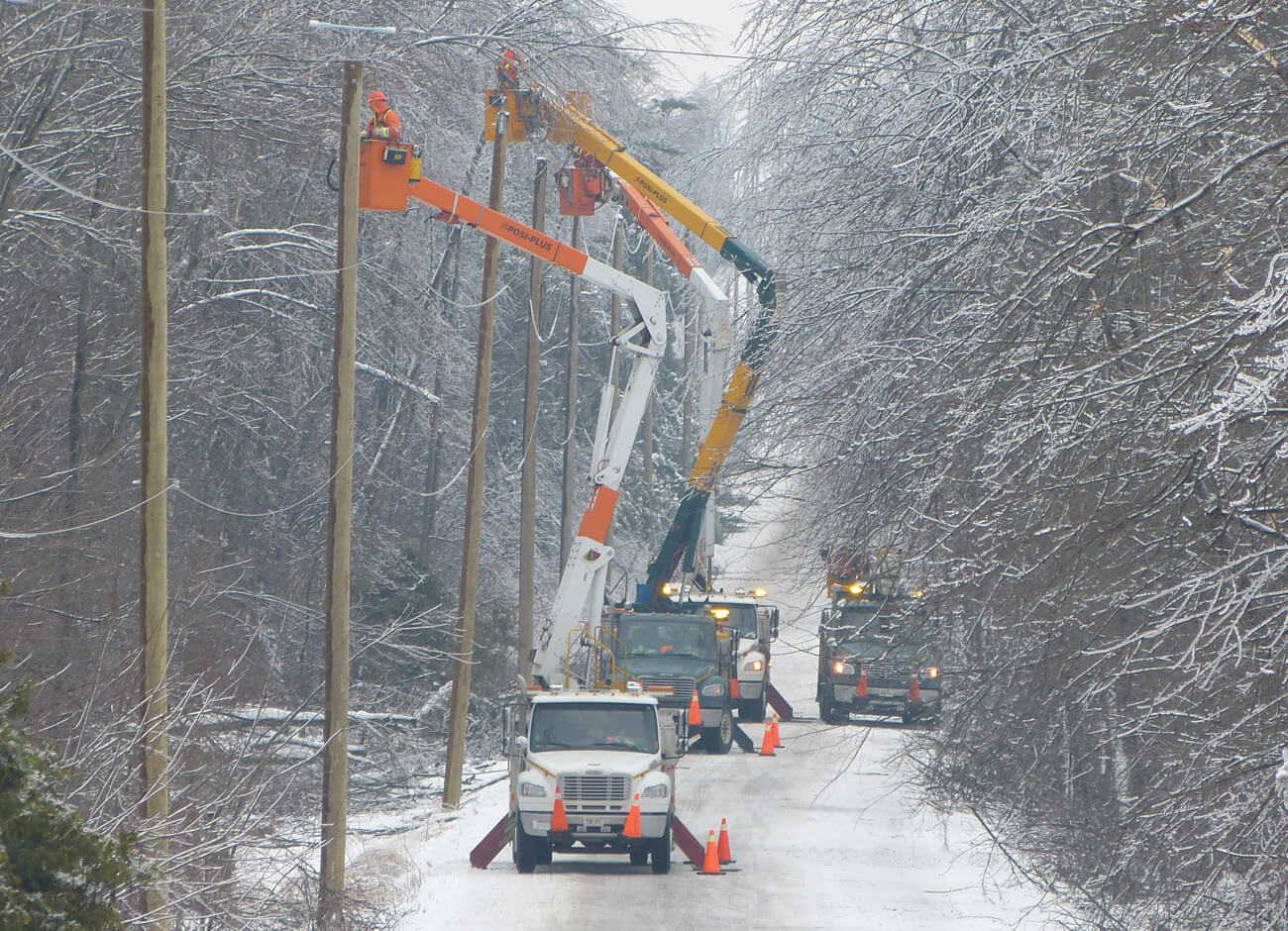 Power wires being repaired on a snowy road