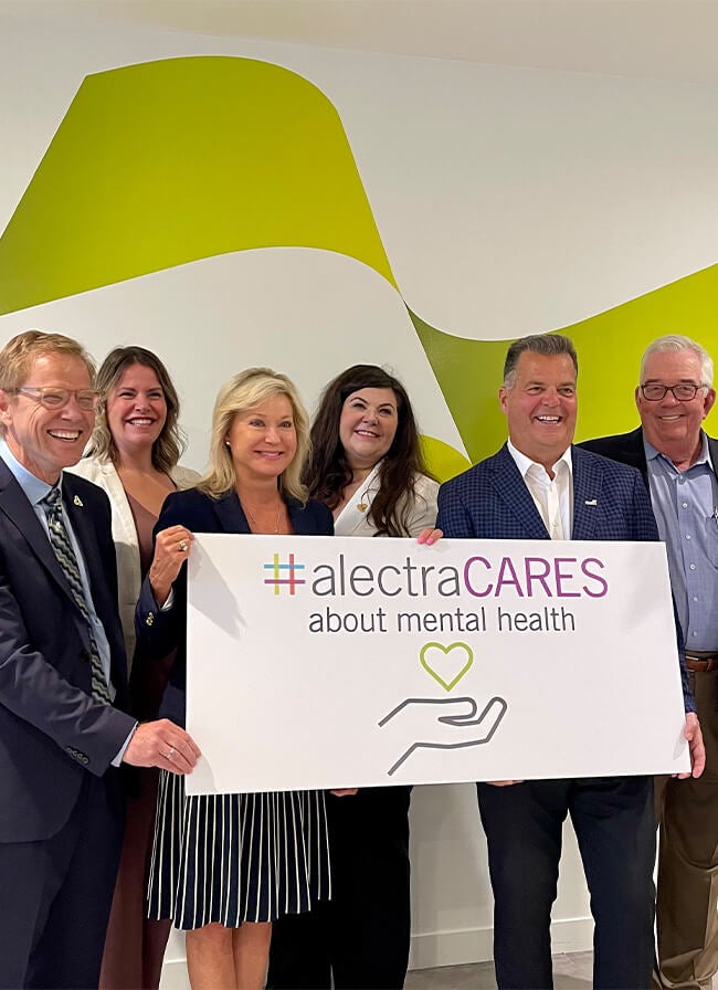Alectra leadership team holding alectraCARES about mental health placard