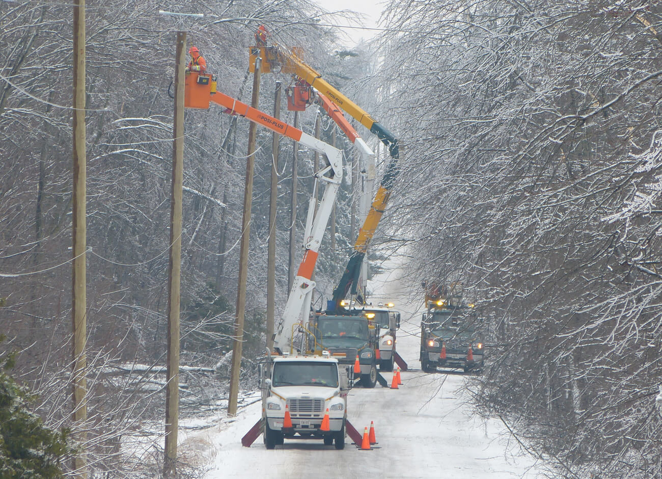 Alectra crew working to restore power on a snowy road.