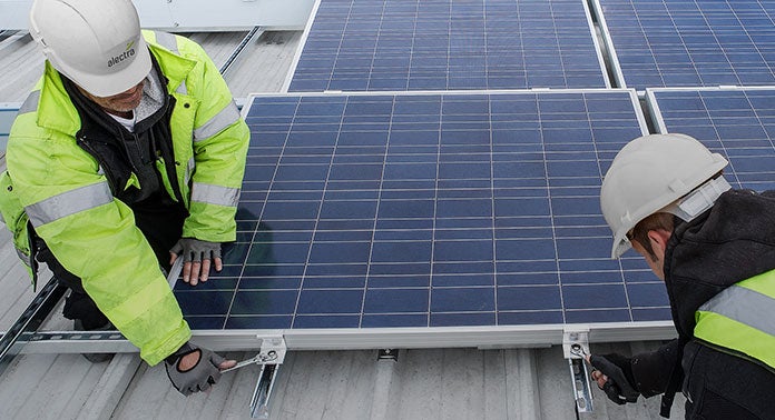 Workers installing solar panels