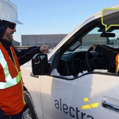 Two workers talking in an Alectra van